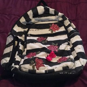 Black and white striped backpack with flowers